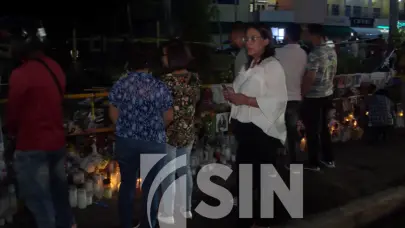 Pese a lluvias, personas llevan flores y velones a la zona cero