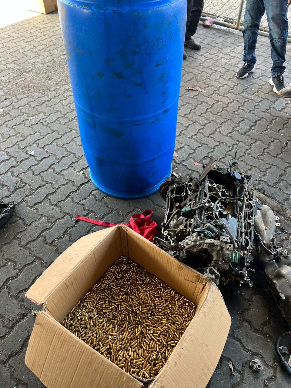 Caja de balas junto a un bidón azul