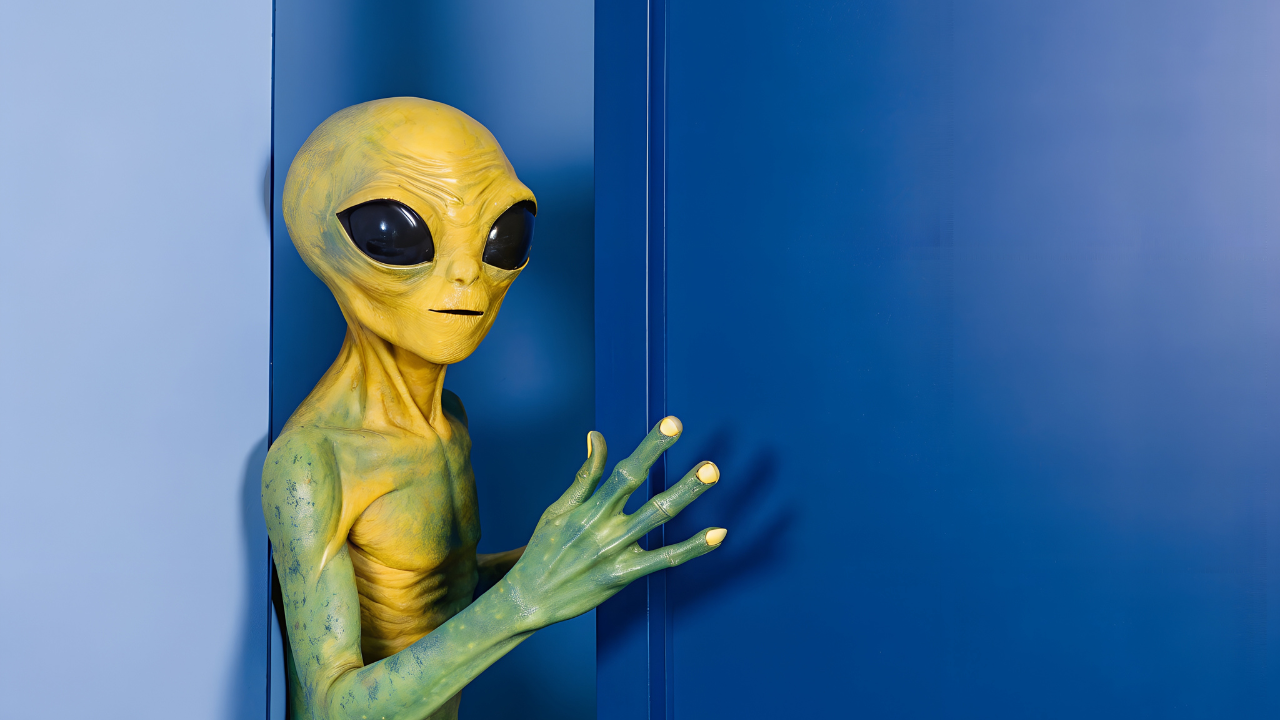 Extraterrestre verde detrás de puerta azul.